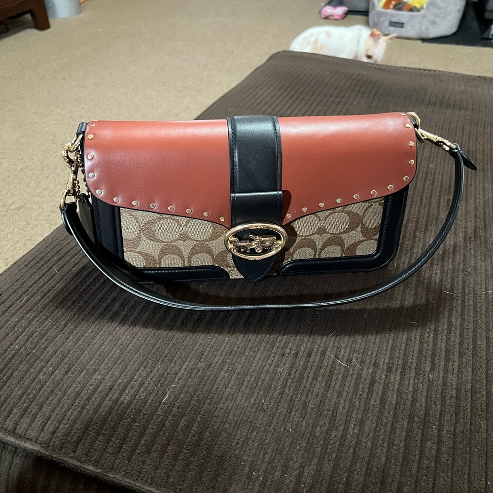 Coach brown signature with black and rust color accents with matching wallet